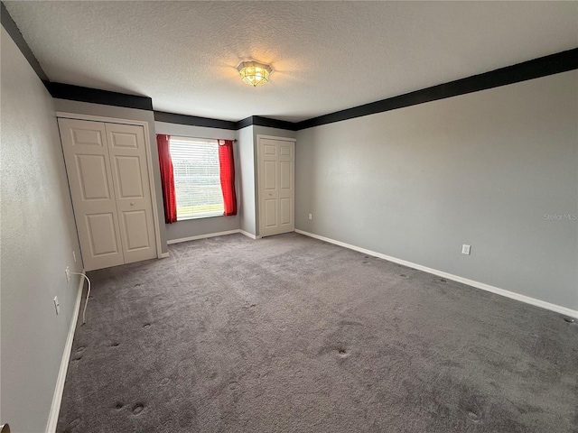 unfurnished bedroom with carpet floors and a textured ceiling