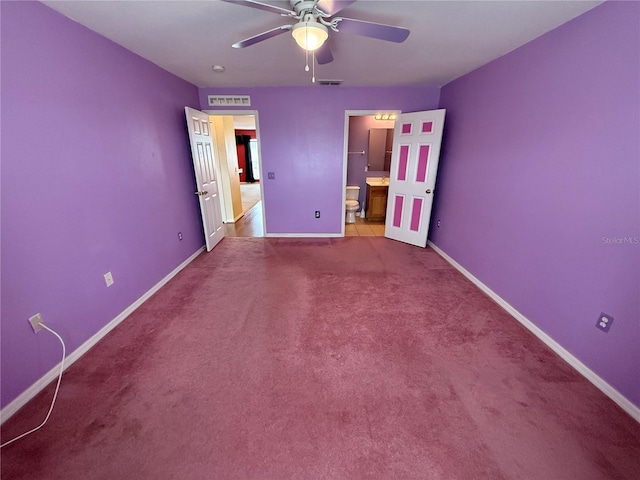 unfurnished bedroom featuring carpet, connected bathroom, and ceiling fan