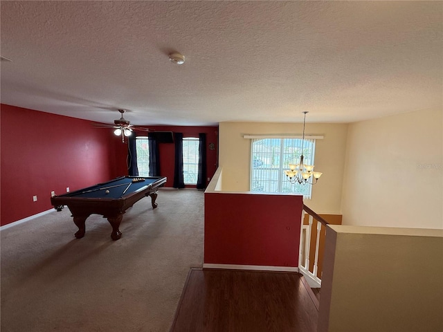 game room featuring a notable chandelier, billiards, a textured ceiling, and carpet flooring