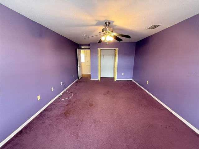 unfurnished bedroom featuring carpet floors, a closet, and ceiling fan