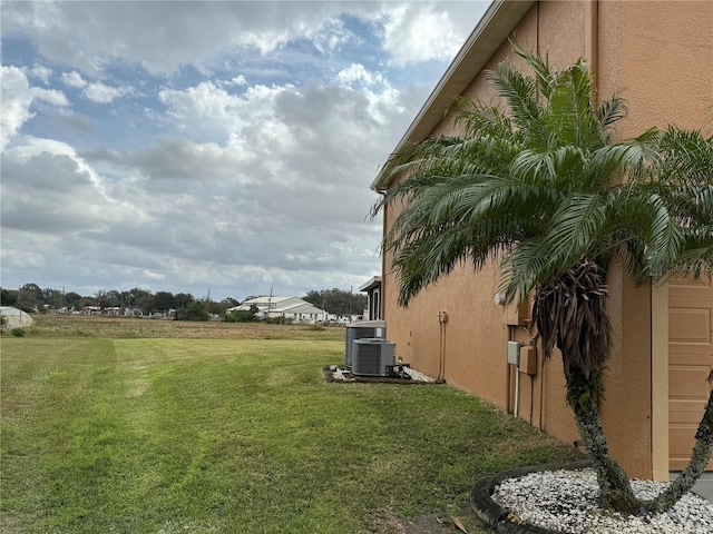 view of yard featuring central air condition unit