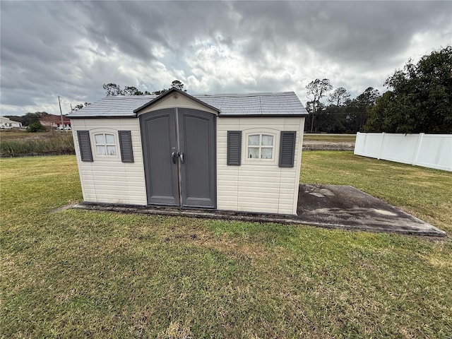 view of outdoor structure featuring a lawn