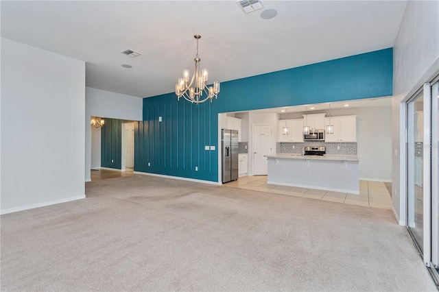 unfurnished living room featuring a notable chandelier and light colored carpet