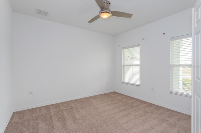 unfurnished room featuring light carpet and ceiling fan