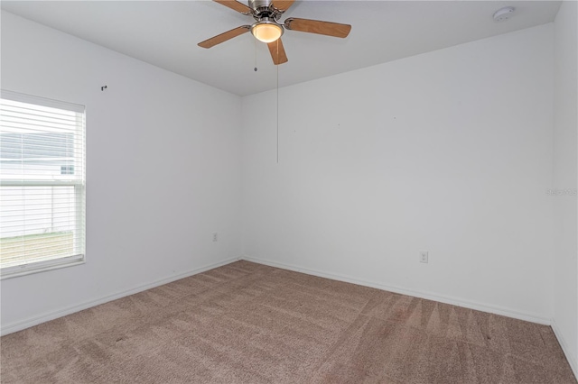 empty room featuring ceiling fan and carpet flooring