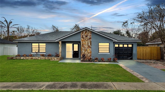 view of front facade featuring a garage and a yard