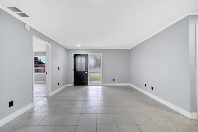 foyer entrance featuring crown molding and light tile patterned floors