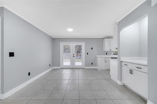 clothes washing area featuring crown molding, light tile patterned floors, and french doors