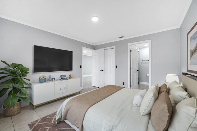 bedroom featuring ensuite bath, ornamental molding, and light tile patterned flooring