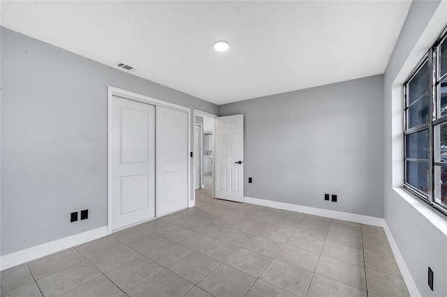 interior space featuring light tile patterned floors and a closet