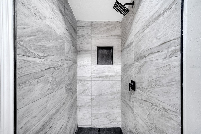 bathroom with a tile shower