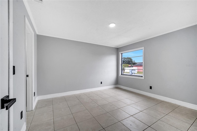 unfurnished room with ornamental molding, a textured ceiling, and light tile patterned flooring