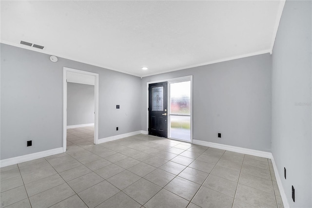 spare room featuring light tile patterned floors and ornamental molding