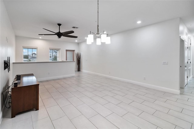 interior space featuring light tile patterned floors and ceiling fan with notable chandelier