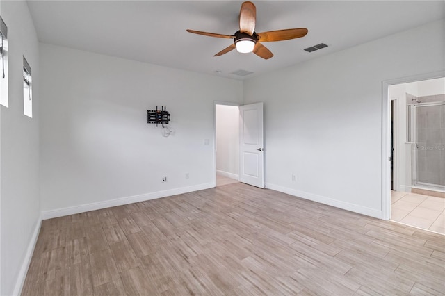 spare room with ceiling fan and light wood-type flooring