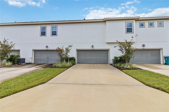 townhome / multi-family property featuring a garage and central AC