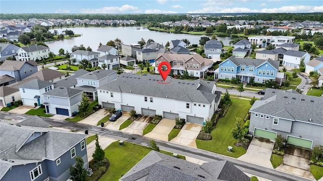 birds eye view of property with a water view