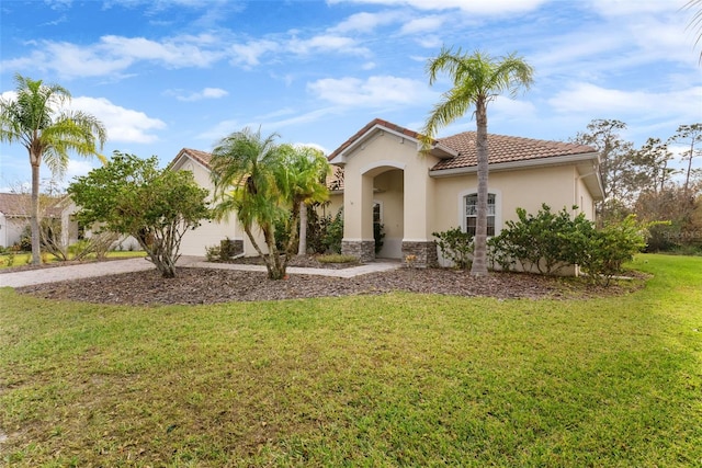 mediterranean / spanish-style home featuring a front yard