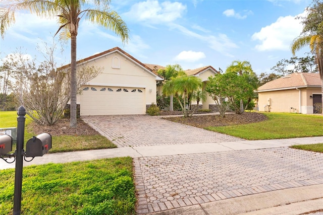 view of front facade with a garage and a front yard