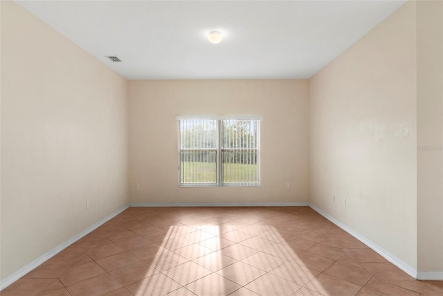 spare room with light tile patterned floors