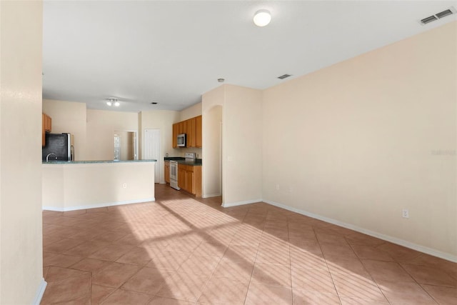 unfurnished living room with light tile patterned floors