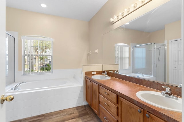 bathroom with separate shower and tub, hardwood / wood-style floors, and vanity