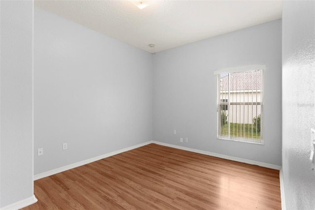 spare room with wood-type flooring