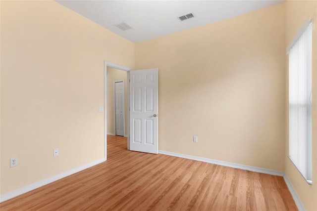 unfurnished room with light hardwood / wood-style floors and plenty of natural light