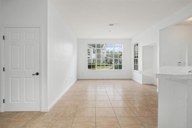 unfurnished dining area with light tile patterned floors