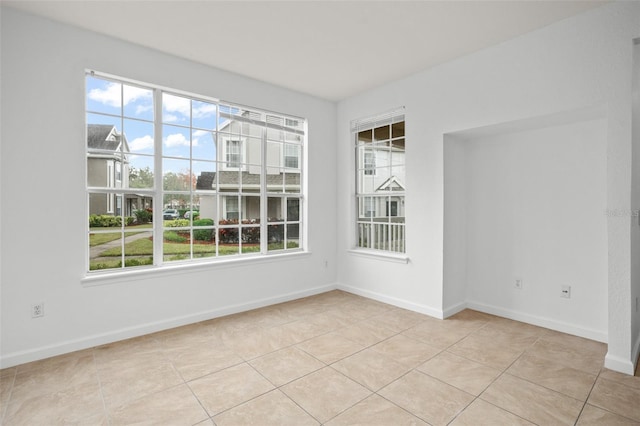 unfurnished room featuring light tile patterned floors