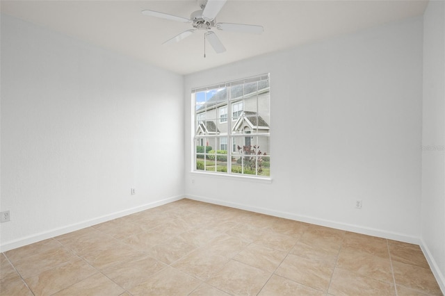 tiled empty room with ceiling fan