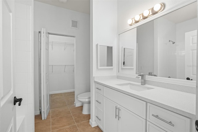 bathroom featuring tile patterned flooring, vanity, and toilet