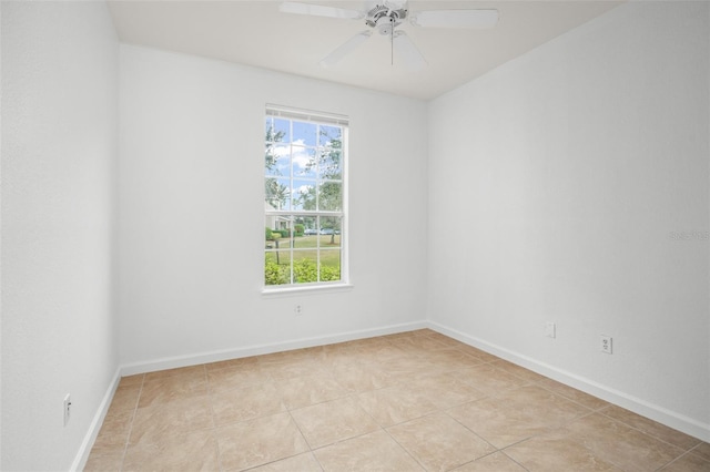 tiled spare room with ceiling fan