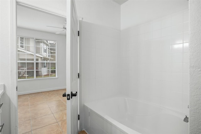 bathroom with ceiling fan, tiled shower / bath combo, and tile patterned flooring