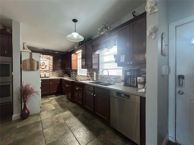 kitchen with pendant lighting, dark brown cabinetry, stainless steel appliances, tasteful backsplash, and sink