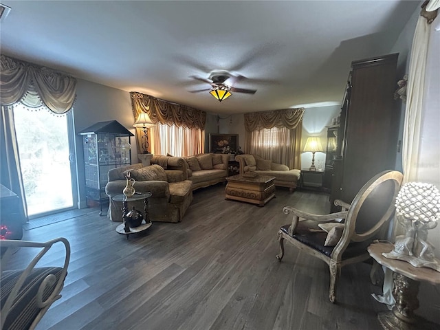 living room with ceiling fan and dark hardwood / wood-style floors