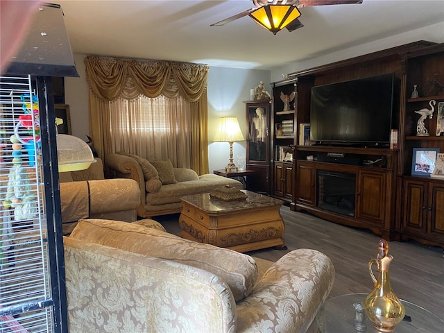 living room with ceiling fan and dark hardwood / wood-style floors