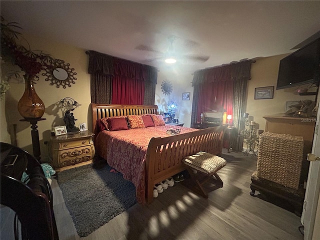 bedroom with ceiling fan and hardwood / wood-style floors