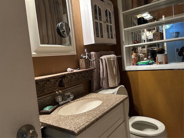 bathroom with toilet and vanity