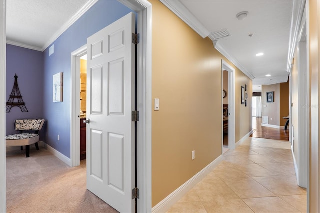 hallway featuring light tile patterned floors and crown molding