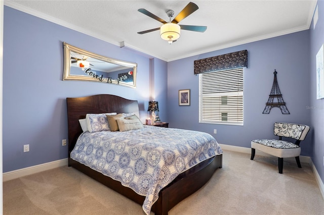 carpeted bedroom featuring ceiling fan and crown molding