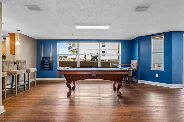 rec room featuring a textured ceiling, dark hardwood / wood-style flooring, and pool table