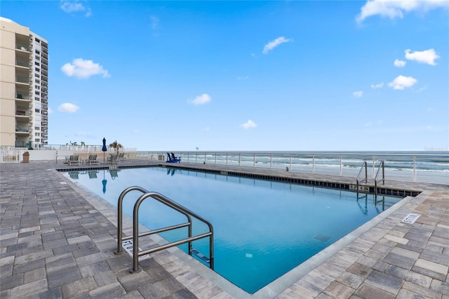 view of pool featuring a water view