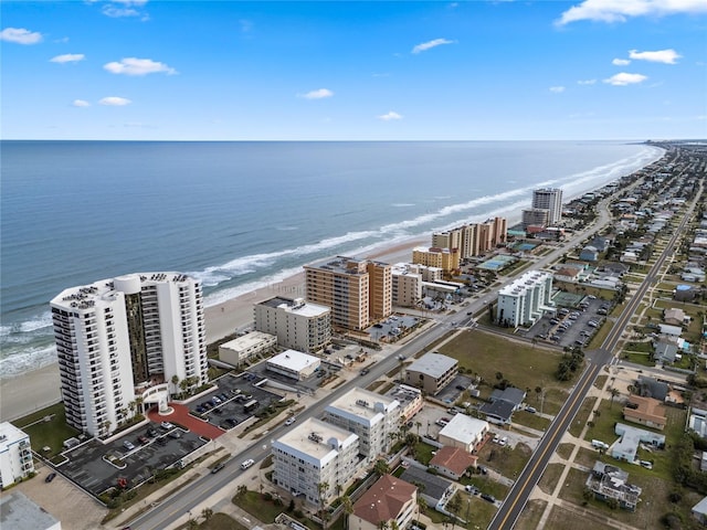 aerial view with a water view and a beach view