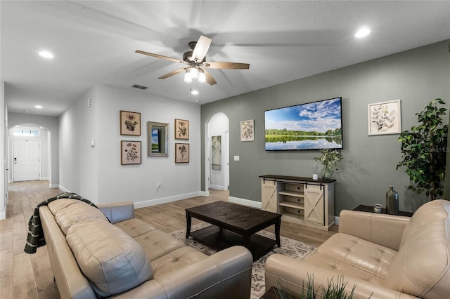 living room with ceiling fan and light wood-type flooring