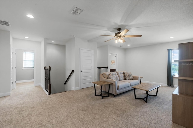 carpeted living room featuring ceiling fan