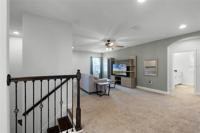 living room featuring ceiling fan and light colored carpet