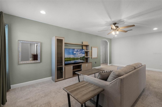 living room featuring light carpet and ceiling fan