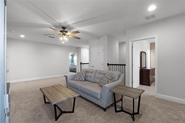 carpeted living room featuring ceiling fan