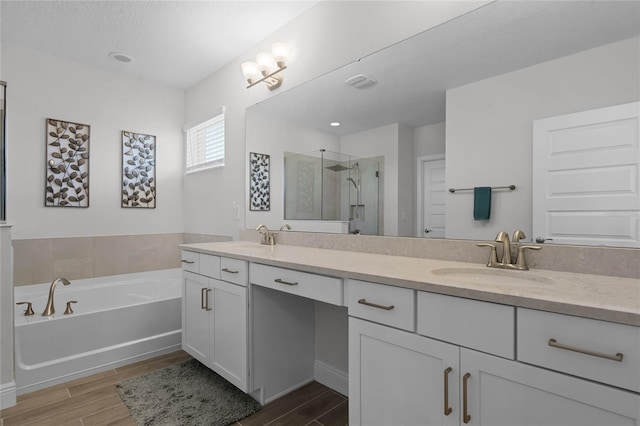 bathroom featuring vanity and separate shower and tub